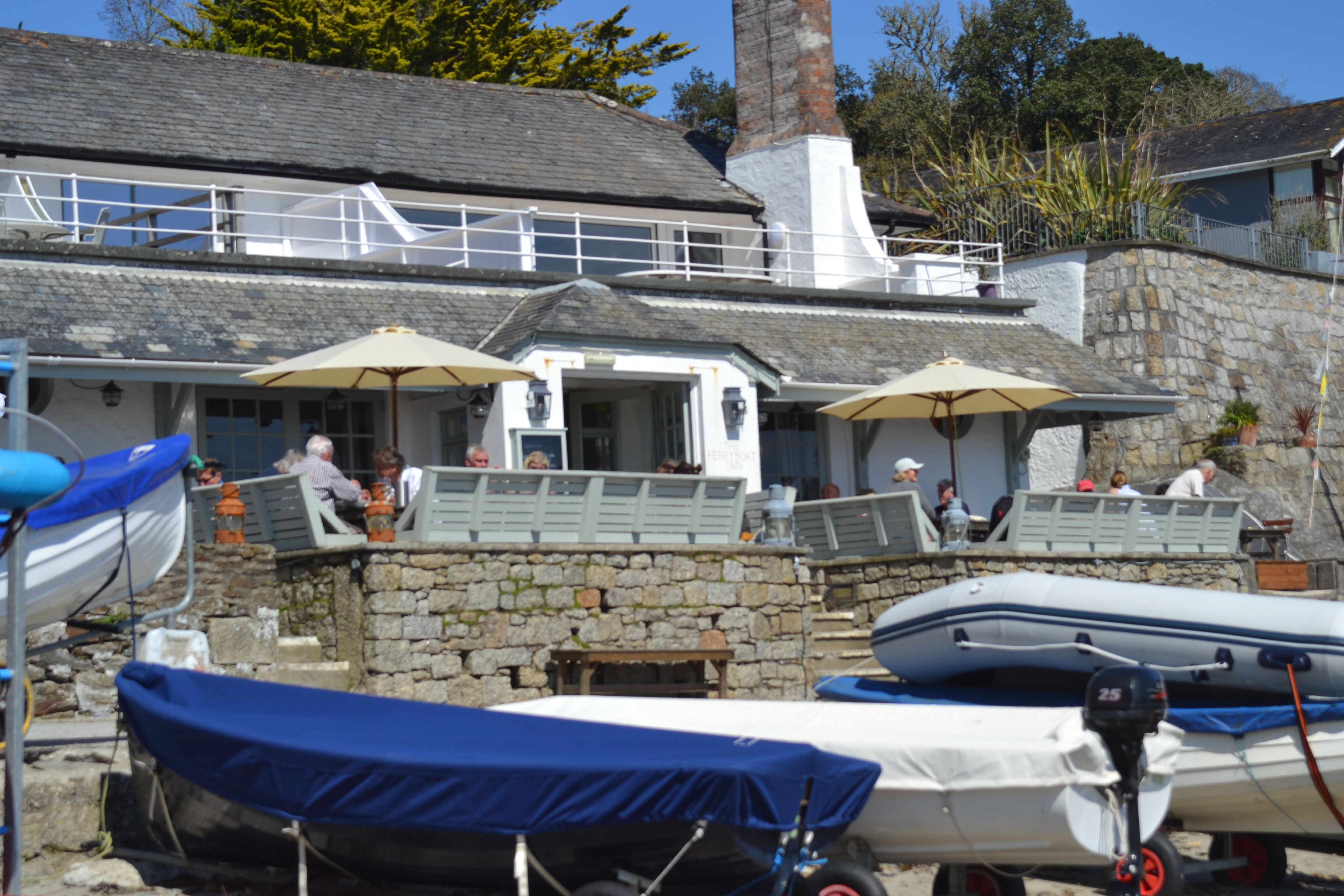 The Ferryboat Inn, perfect for lunches and evening suppers with a view of the Helford River. You can see Demelza in the top corner of the photograph.