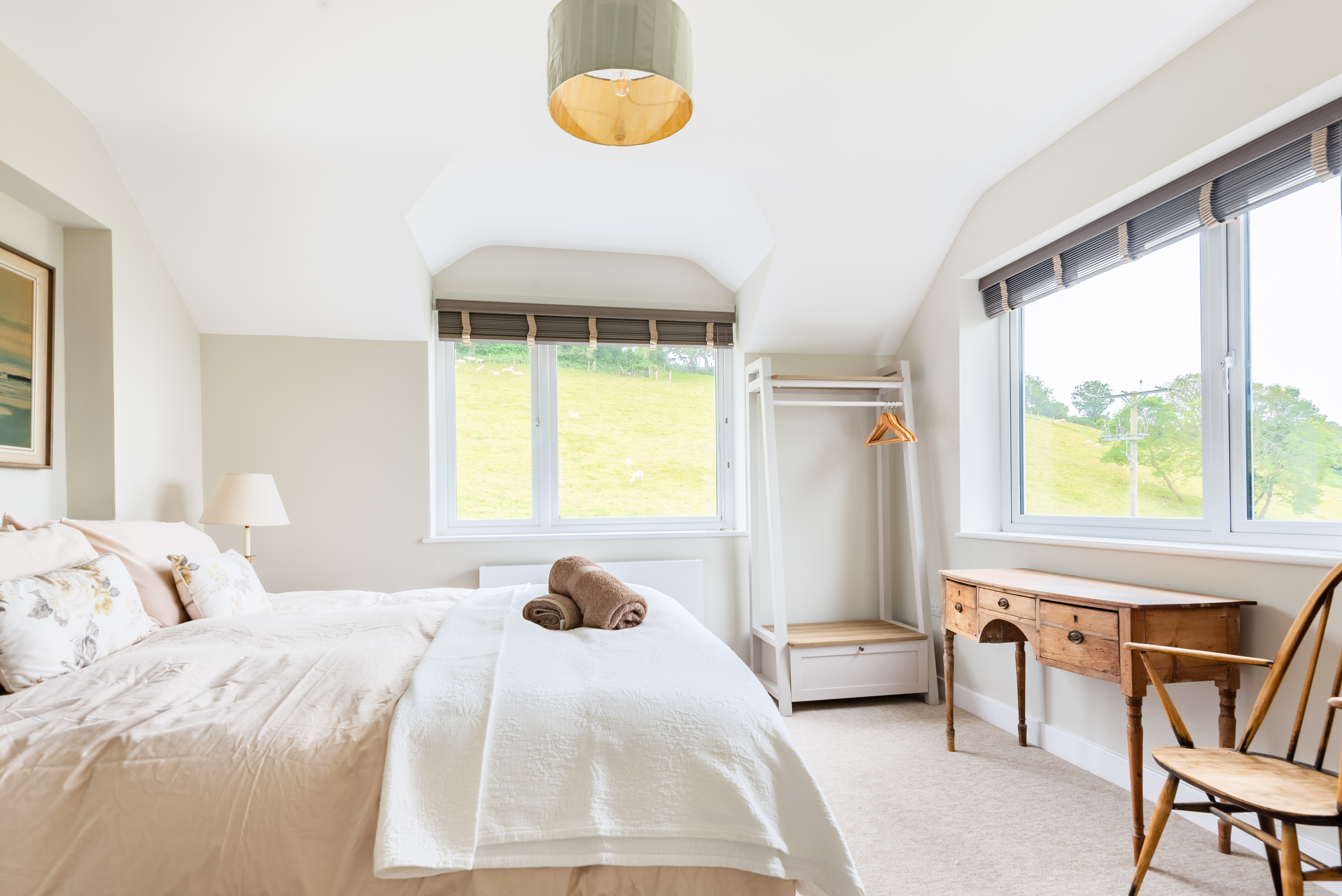 The main bedroom-Bedroom 2-with en suite bathroom and views over the village towards Salcombe