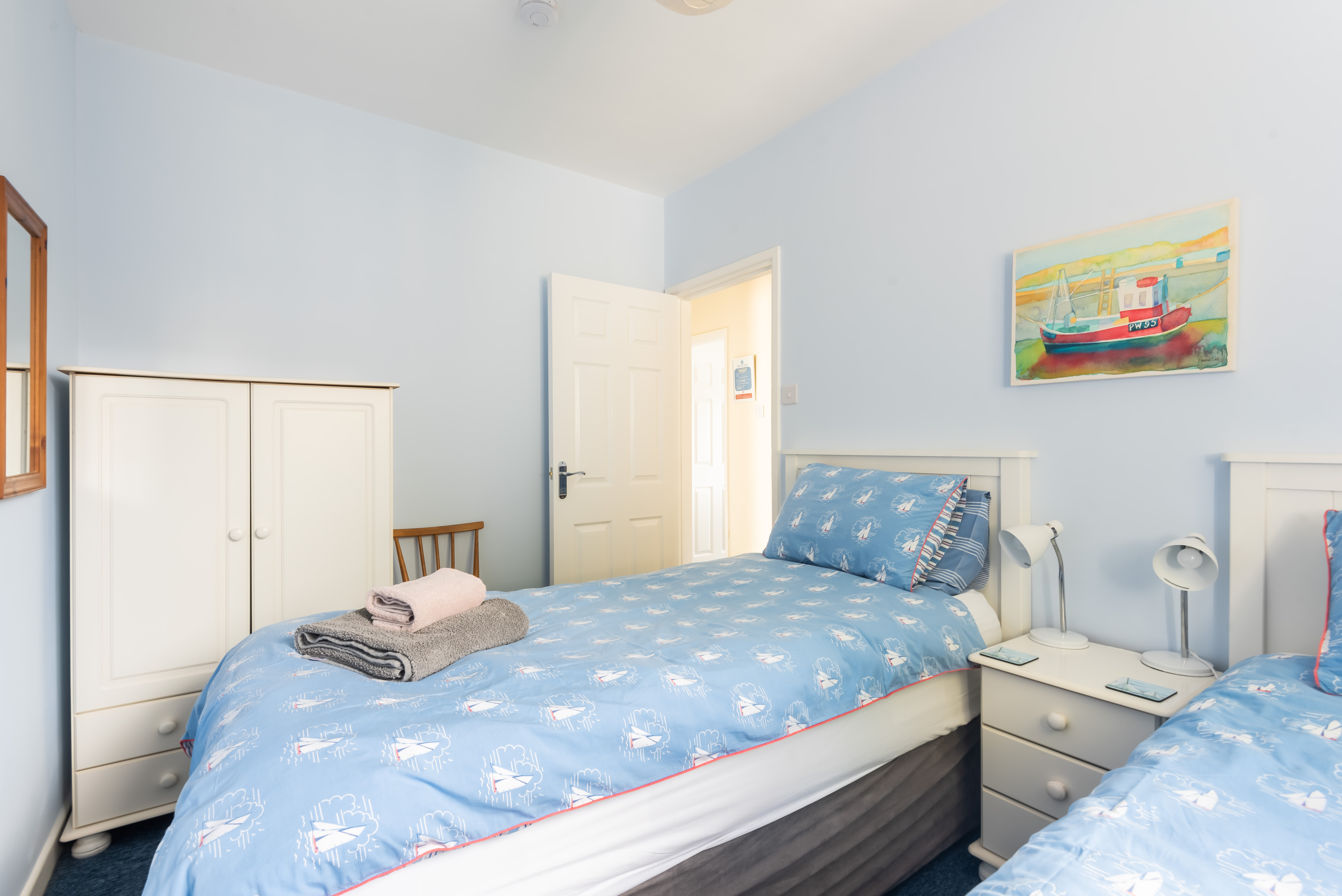 Storage space in the twin room with its beachy feel.