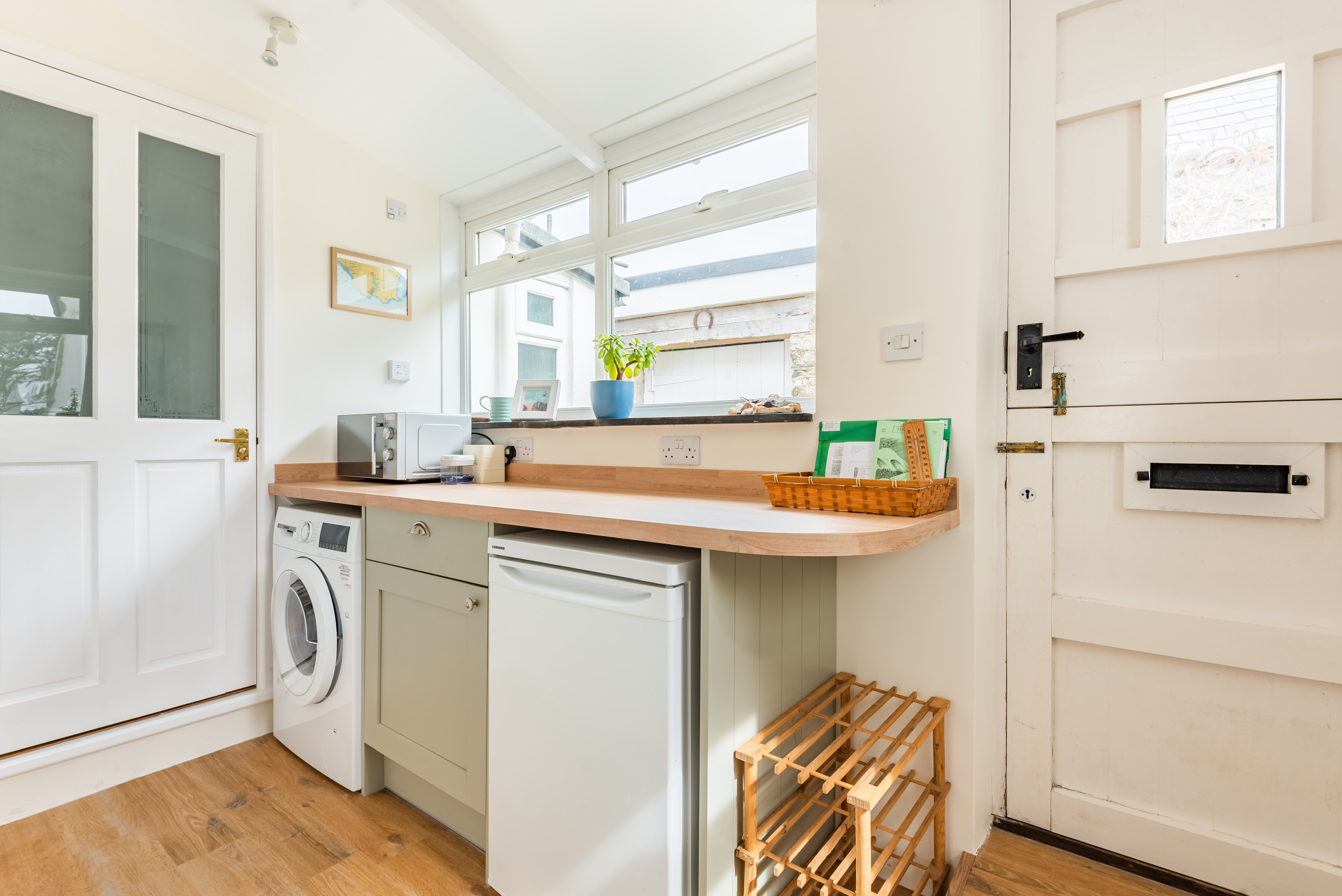 Useful boot/utility room with shower room door to the left