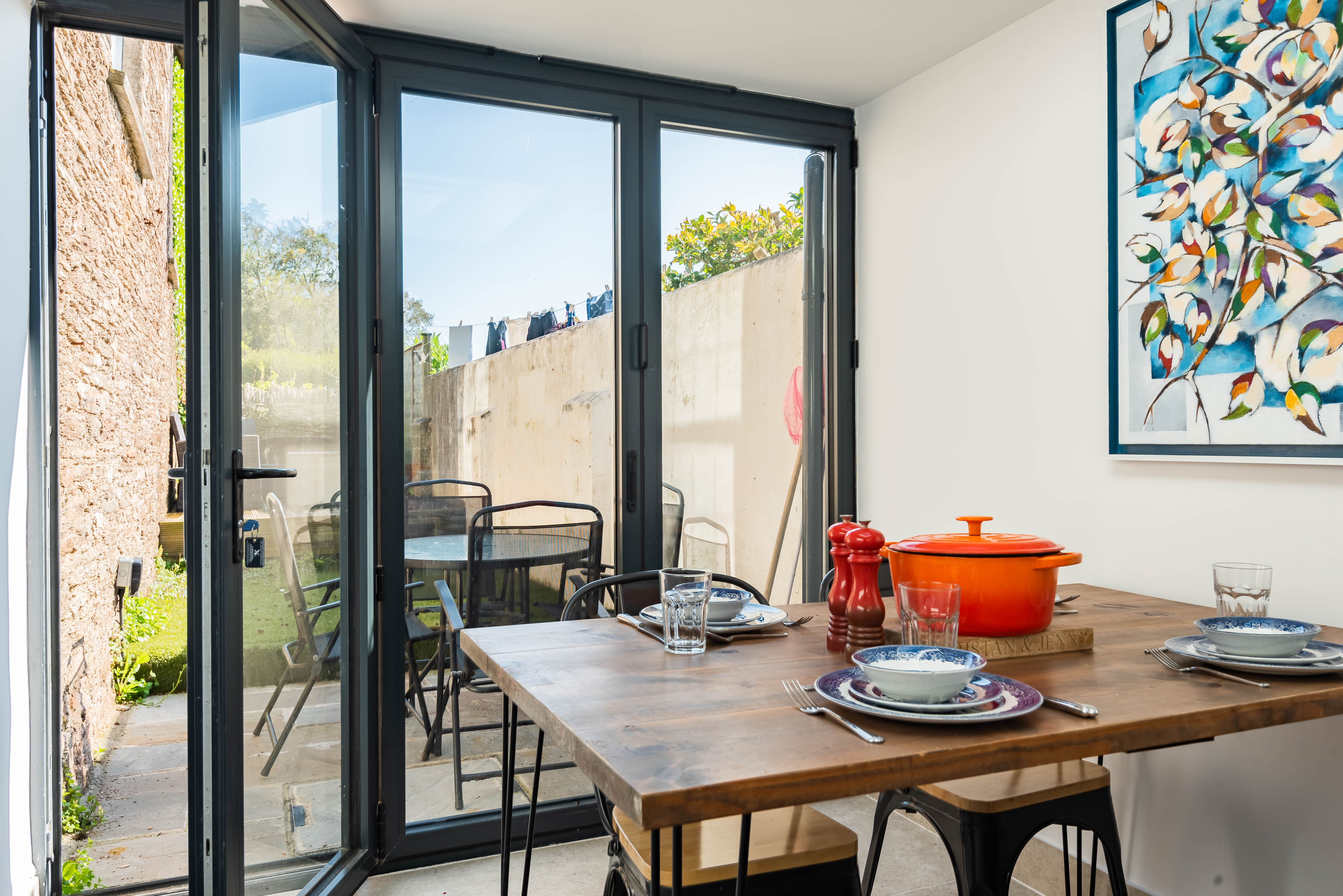 The kitchen diner opens out onto a sunny garden area, with al fresco dining and rattan set for evening drinks relaxing in the sun.