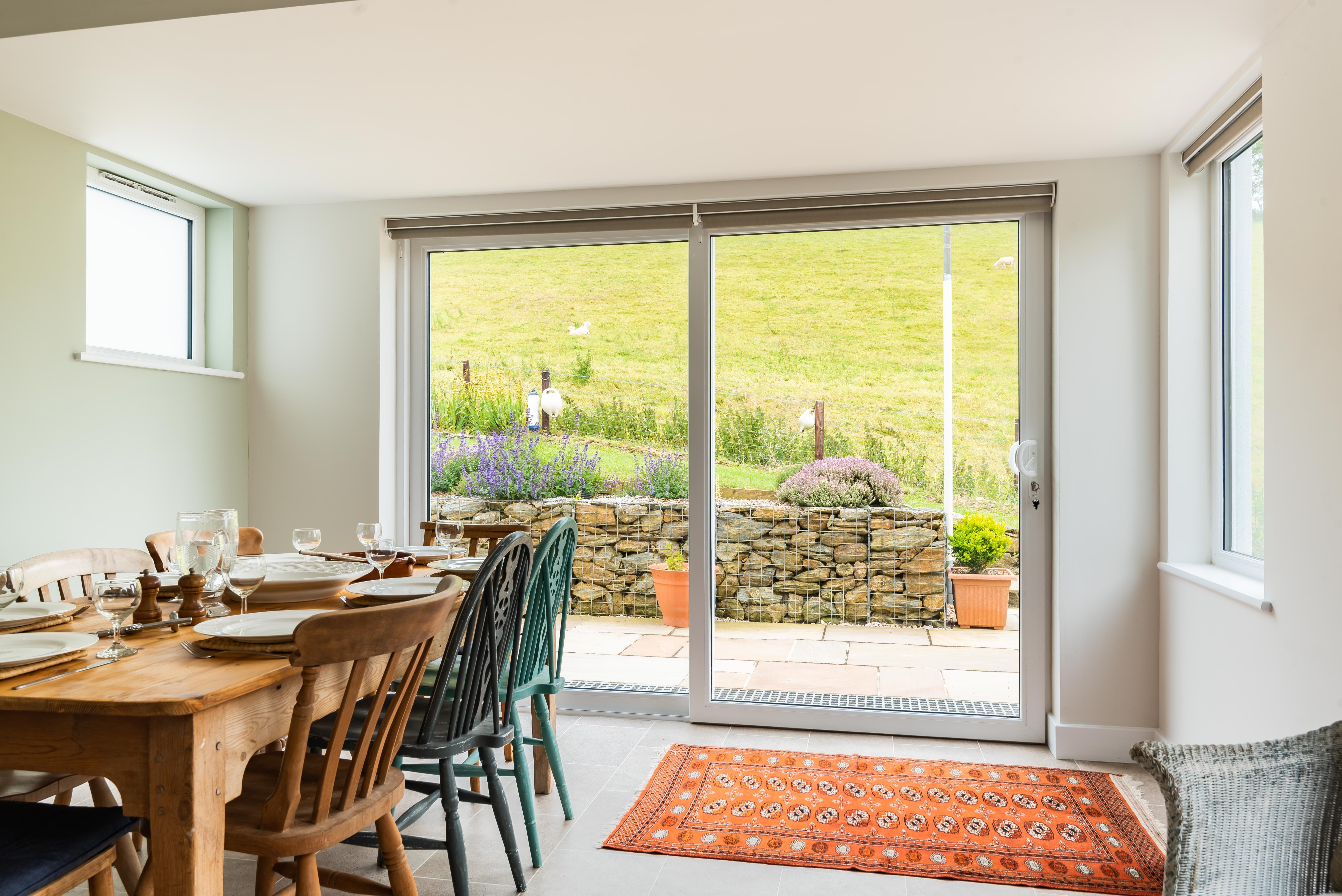 The dining space opens up onto the terrace and garden.
