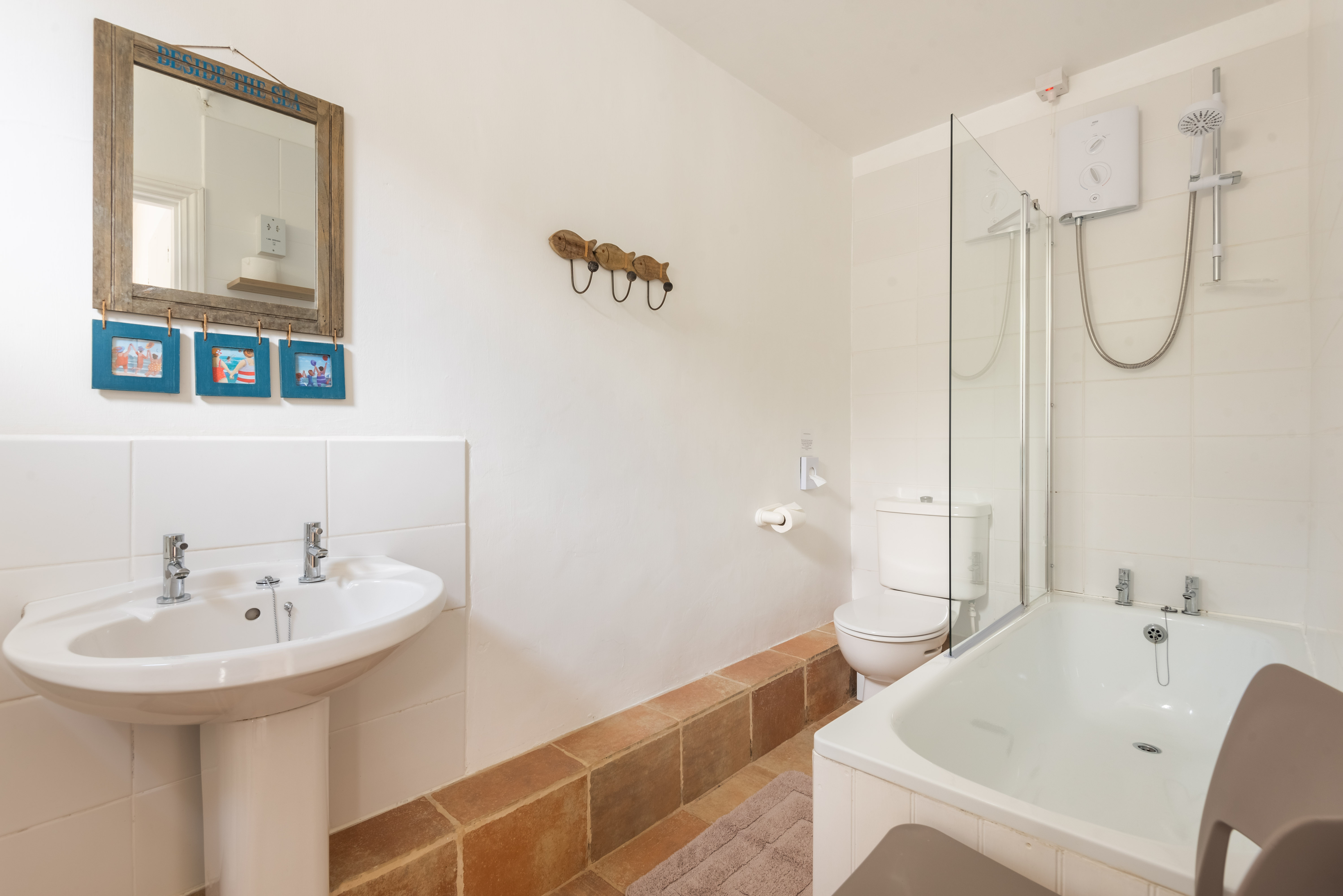 Family bathroom with overhead shower and shower screen.