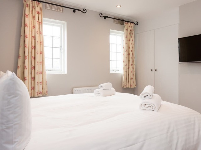Bedroom 1 with built-in wardrobe and Smart TV
