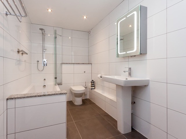 Modern family bathroom with shower over bath